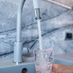 taking water in glass from tap 2