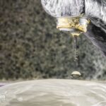 Hard water in NYC? Faucet with mineral buildup and dripping water. Potential hard water issues.