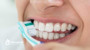 Brushing teeth with lead in water. Close-up of toothbrush on white teeth. Oral hygiene.