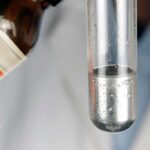 Mercury water testing. Test tube with mercury metal for water quality analysis.