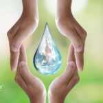 Hands holding a water drop. Protecting family from lead in household water with water testing.