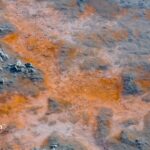 Rusty water. Water with orange and brown discoloration. Possible iron contamination. Water quality issue.