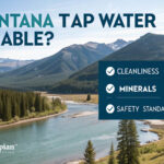 Is Montana tap water drinkable? Clean water flowing from a tap with mountains in the background.
