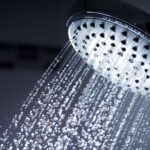 Shower head with running water. Rusty tap water can be tested for contaminants.