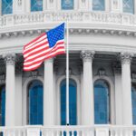 US Capitol building with American flag. Debate over fluoride in NYC tap water. Water testing.