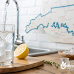 Is Arkansas tap water drinkable? Glass of water with ice and lemon. Arkansas state map in background. Clean, safe drinking water.