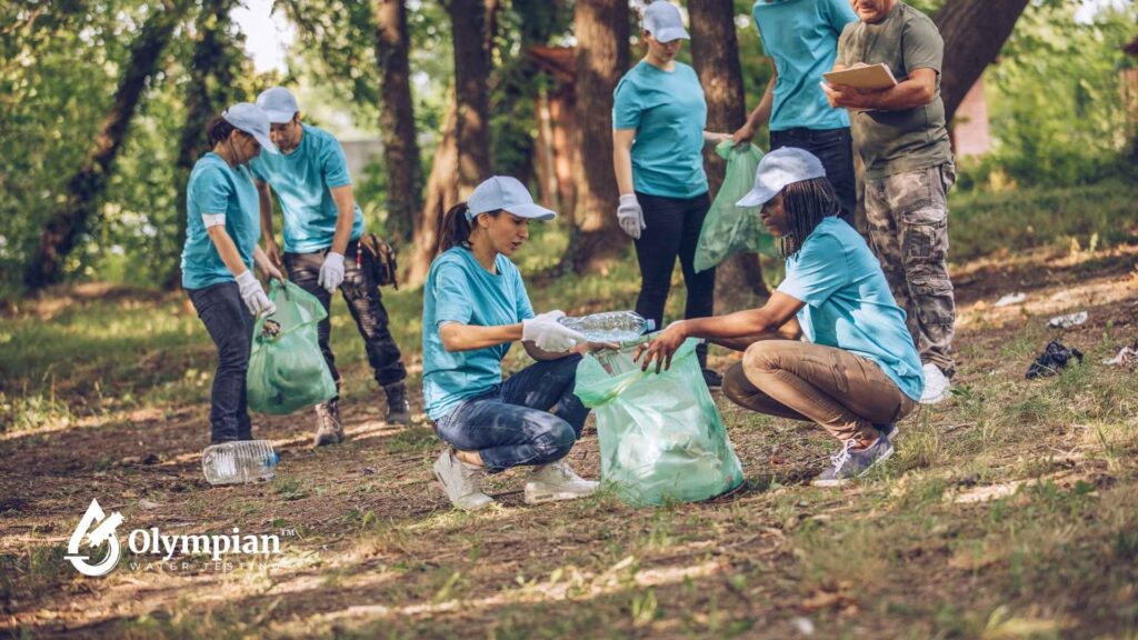 Volunteers clean up water systems. People collect trash, improving water quality and environmental health.