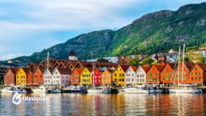 Bergen, Norway, water quality. Colorful buildings line the harbor with boats, mountains in the background.