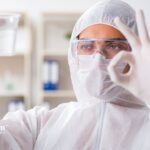 Lab worker in protective suit testing private well water quality. Choosing the right lab for water testing.