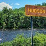 Hudson River sign with trees and water. Water quality in Hudson County.