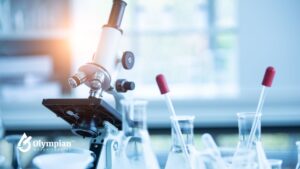 Microscope and lab beakers for well water testing. Lab-based regulatory water analysis.