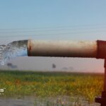 Well water flowing from a pipe. Regular well water testing is important for home water safety.