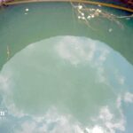 Well water with volatile organic compounds (VOCs) reflecting the sky. Water testing is recommended.