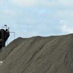 Manganese mining equipment and a large pile of manganese. Well water contamination risk.