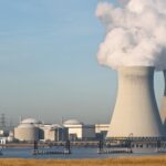 Uranium in Northeast Wells: Nuclear power plant with cooling towers emitting steam. Water testing concept.