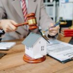 CT Real Estate Attorney at desk with gavel, contract, and house model. Well tests are important.