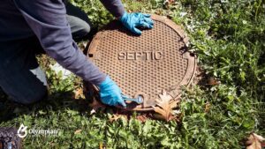 Septic system inspection. Man with gloves checks septic tank. Well water safety concept.