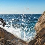 Cape May rising seas impact: Ocean waves crash against rocks. Well water testing.