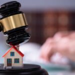 NY Real Estate Attorney: Gavel striking house, scales of justice. Legal advice for property well tests.