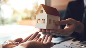 Somerset County real estate: Hands exchanging a model house. Consider well water testing before buying a property.