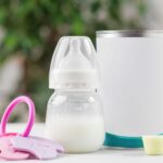 Baby formula, bottle, scoop, and toy. Well water testing is essential before making baby formula.